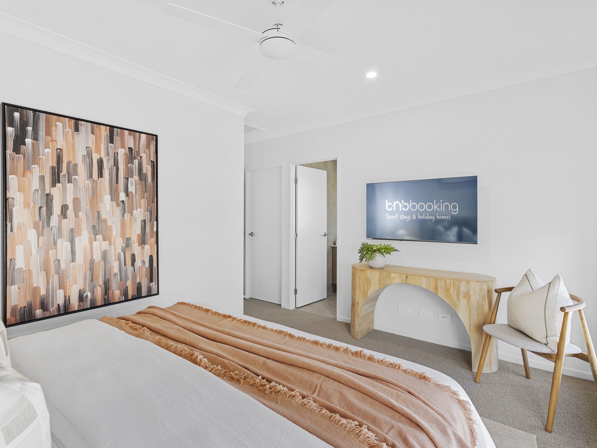 AirBNB — bedroom with abstract art and timber arch console