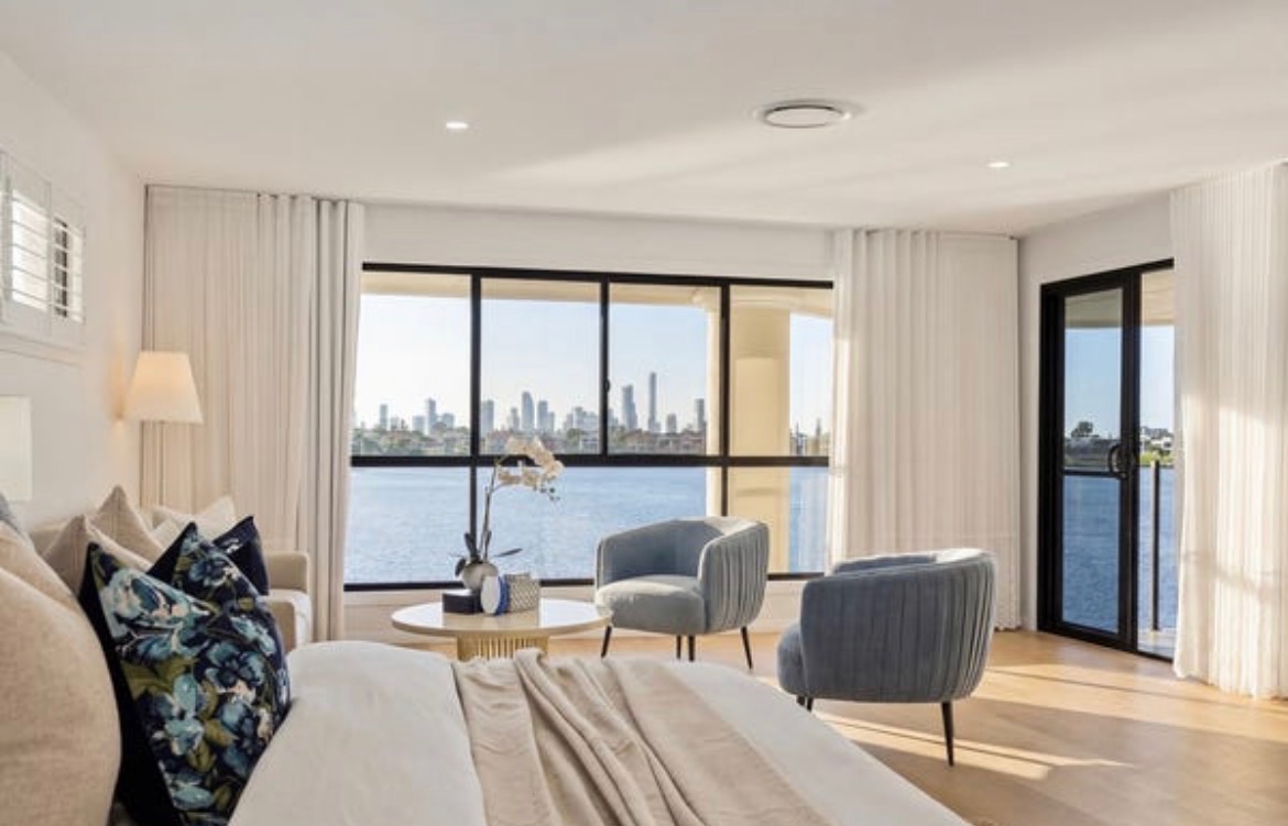 Vacant styling — skyline bedroom with blue velvet chairs