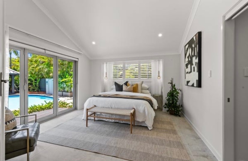 Vacant styling — bedroom with pool view
