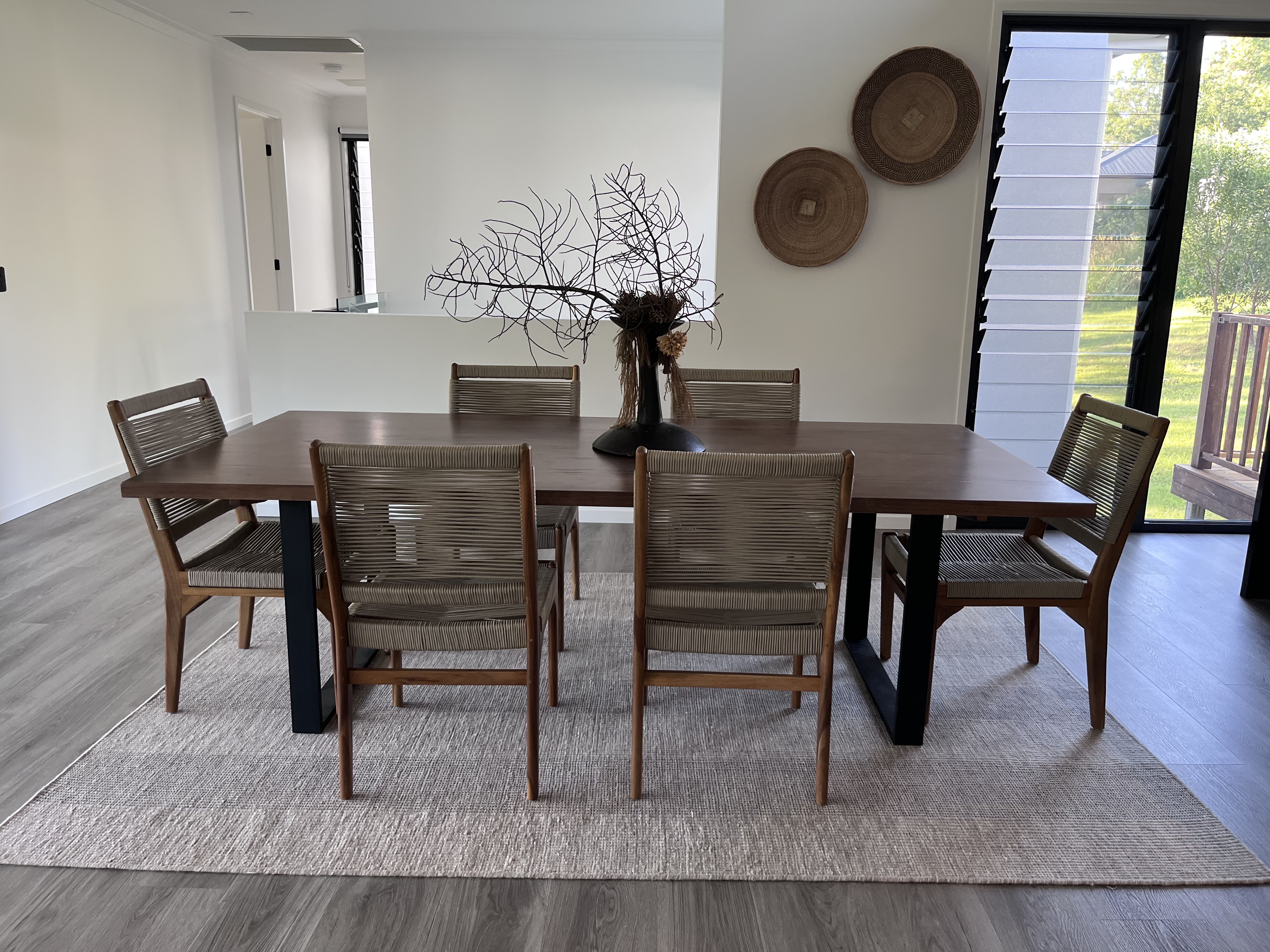 Interior design — dining table with woven chairs