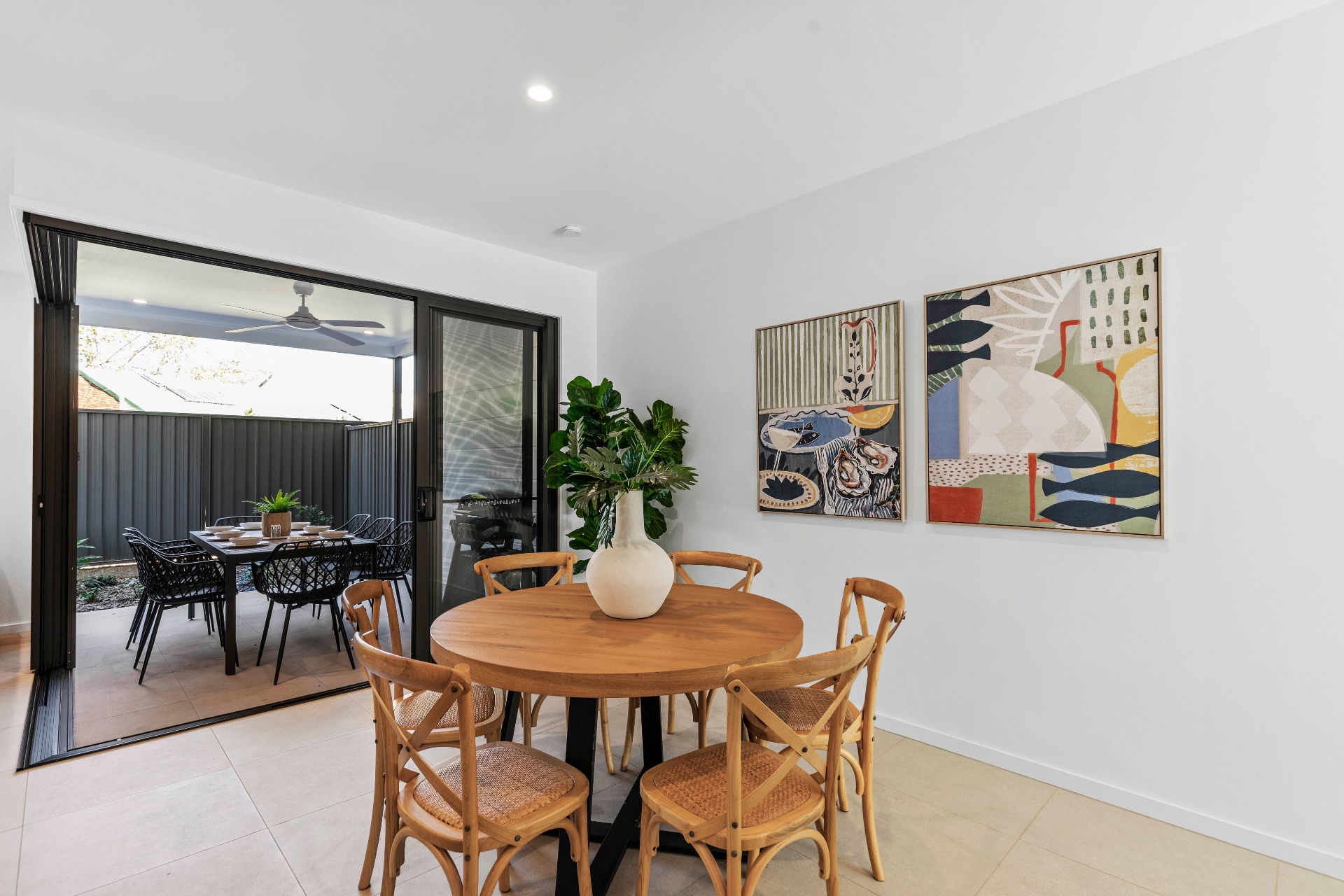 AirBNB — dining nook with abstract gallery wall and alfresco view