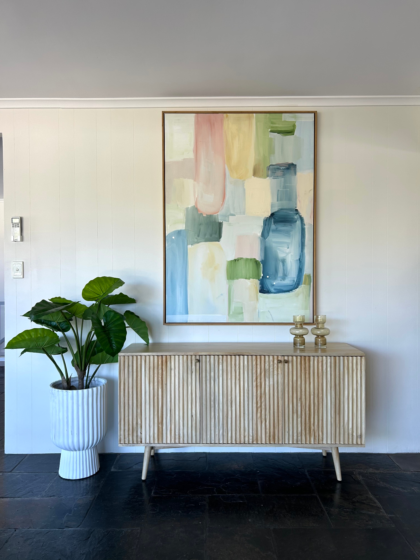 Interior design — sideboard with pastel art